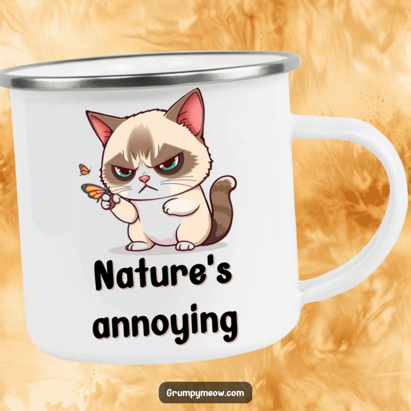 Funny grumpy cat disdainfully batting away a playful butterfly with one paw on a camping mug, for outdoor adventures, a funny gift.