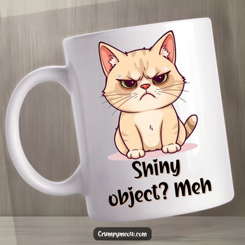 Funny grumpy cat mug showing a cat looking unimpressed by a bright, shiny object, a humorous gift for cat lovers.