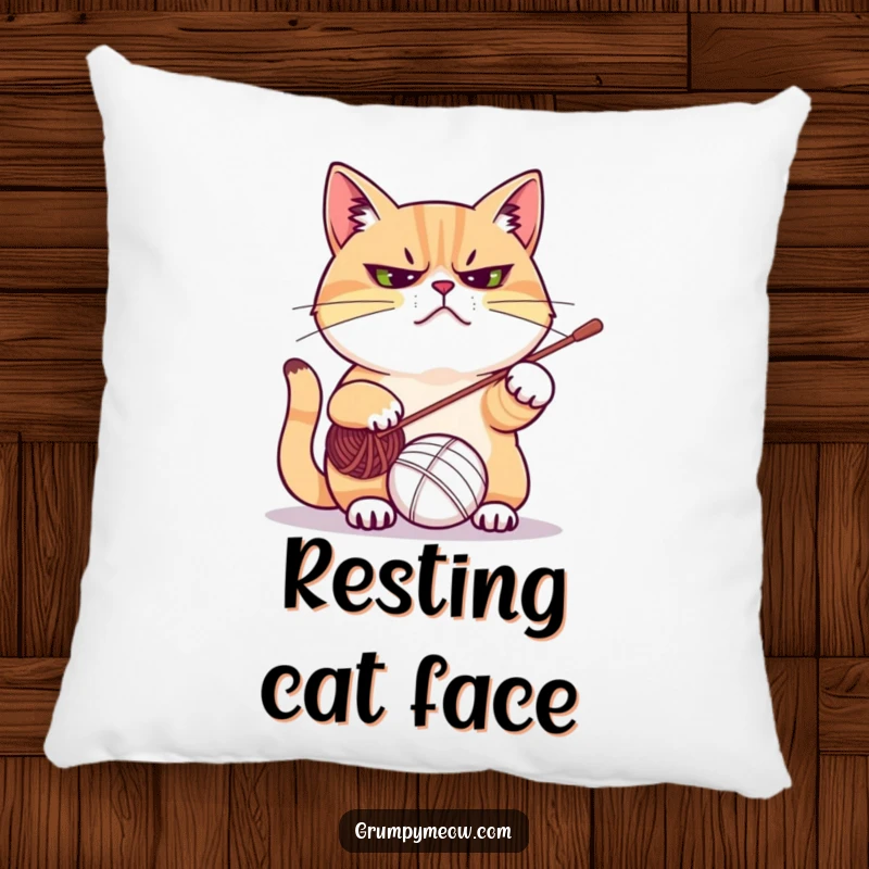 Funny pillow designed with a grumpy cat frowning while playfully attacking a ball of yarn, perfect for adding humor to any room.