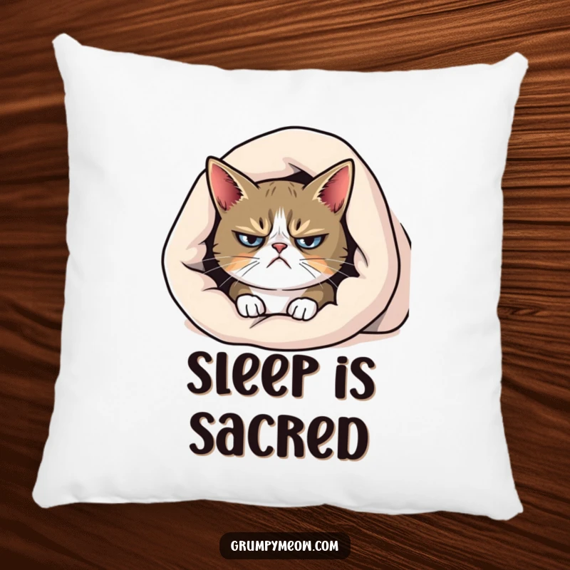 Funny grumpy cat pillow, peeking from under a blanket with a frown, ideal for cozying up with a touch of sass.