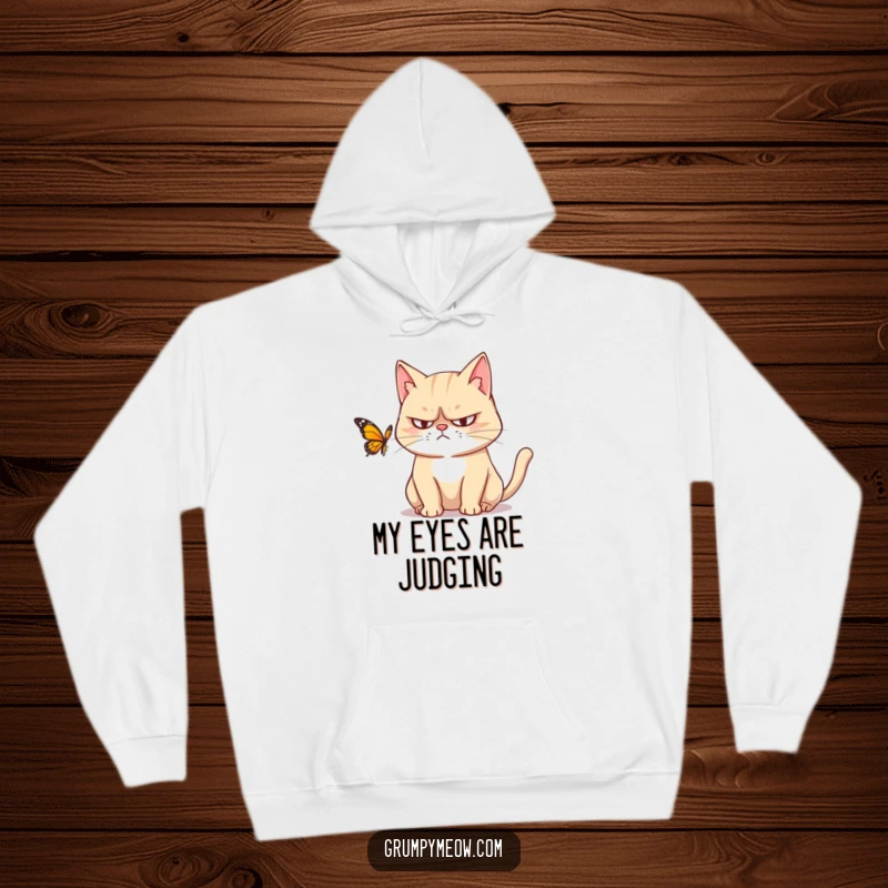 Funny hoodie: A grumpy cat with narrowed, suspicious eyes intently watches a butterfly, conveying a humorous sense of feline annoyance.
