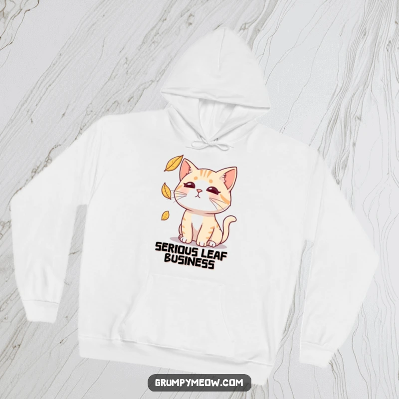 Funny hoodie featuring a deadpan cat attempting to catch a falling leaf, offering warmth and a sarcastic vibe.