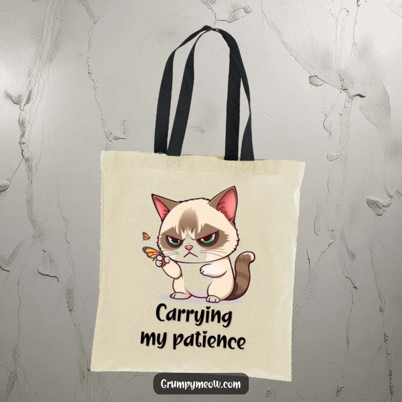 Funny grumpy cat disdainfully batting away a playful butterfly with one paw on a tote bag, a stylish funny gift.